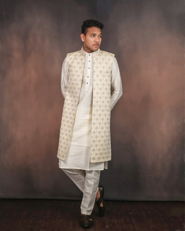 Cream long koti set showcasing intricate embroidery details