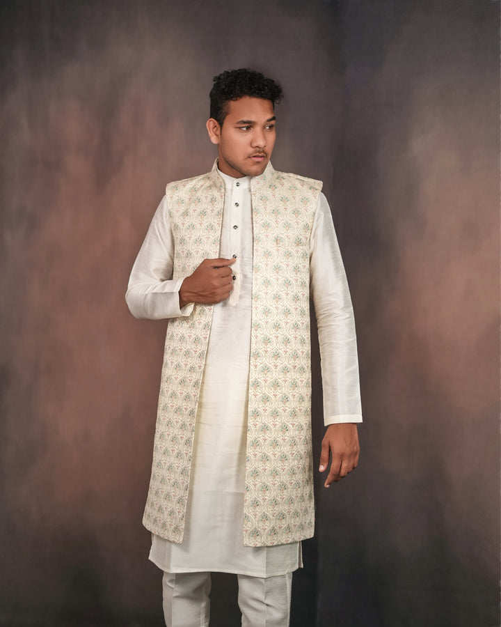 Cream long koti set showcasing intricate embroidery details