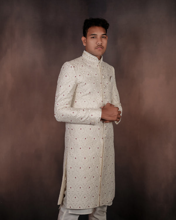 Off-white Indo-Western outfit with detailed embroidery, showcasing a blend of traditional and modern design elements. Ideal for formal occasions.