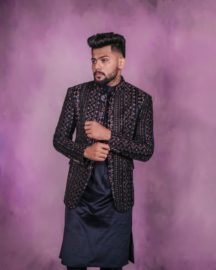 A distinctive navy blue velvet Jodhpuri Kafni ensemble featuring a velvet kurta and trousers.