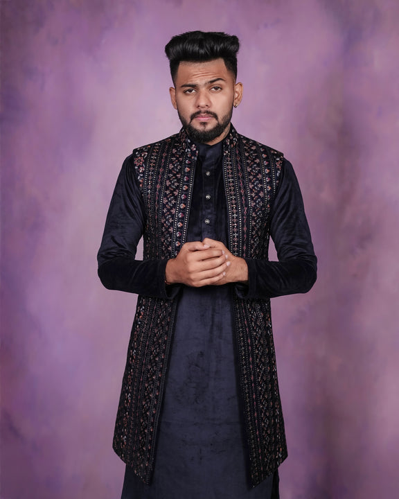 An opulent navy blue velvet long koti set for men, featuring a richly textured velvet koti paired with a complementary kurta and trousers.