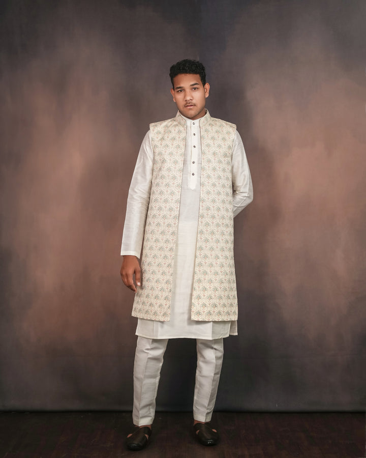 Cream long koti set showcasing intricate embroidery details