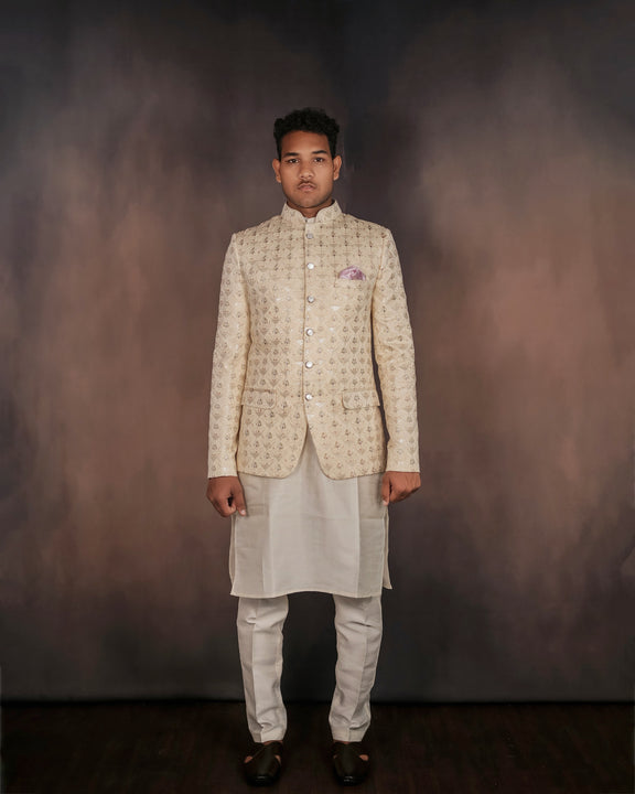 A glamorous cream Jodhpuri suit with exquisite embroidery.