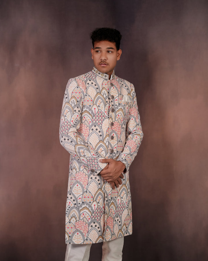 Luxe men’s white velvet Indo-Western outfit with vibrant multi-colored embroidery, designed for grand occasions and special events.